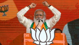 Indian Prime Minister Narendra Modi addresses a mass campaign rally this month, despite the COVID pandemic, on behalf of his Hindu nationalist Bharata Janata Party in Kolkata, India