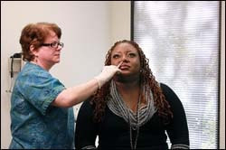The figure above is a photograph showing a health care professional administering a nasal influenza vaccine.