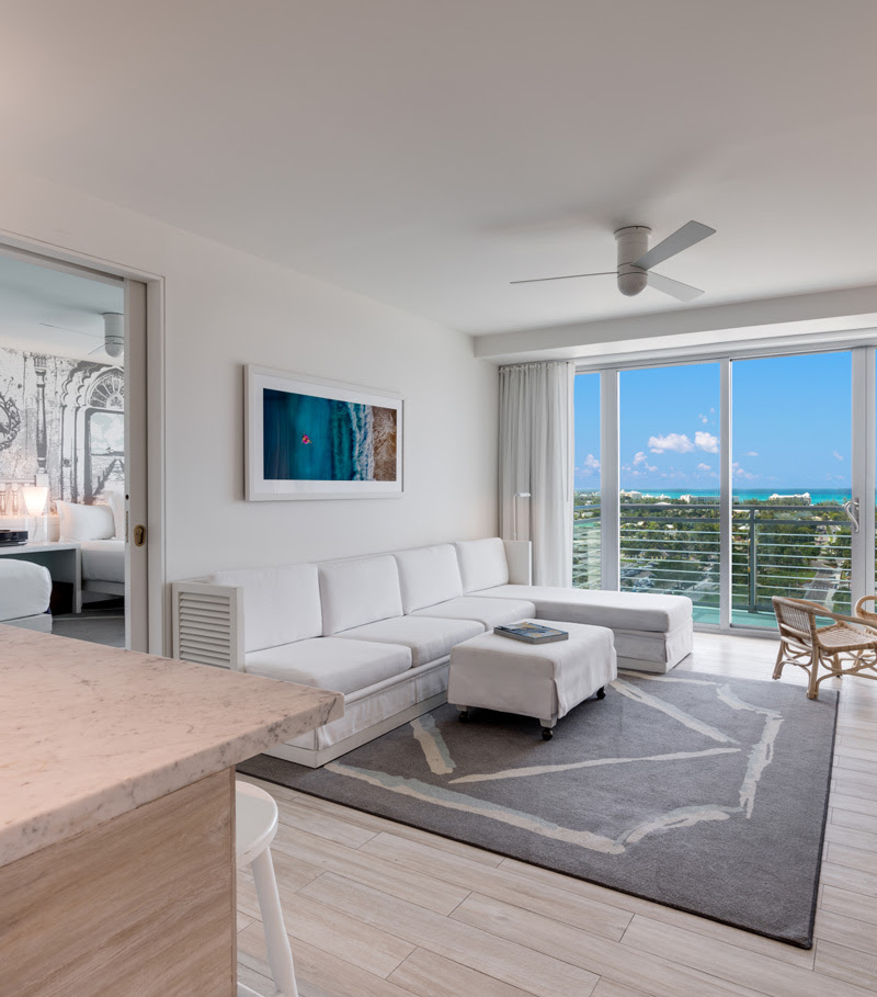 Photo of the interior of a suite at SLS Baha Mar, including a stunning ocean view from the balcony