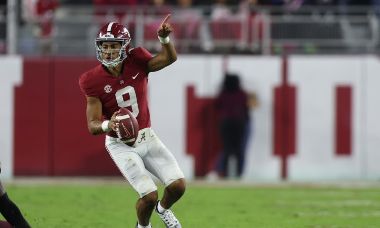 Alabama QB Bryce Young (#9) directs wide receivers downfield against Mississippi State