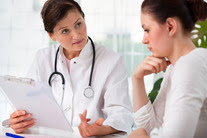 Doctor examining medical records with patient