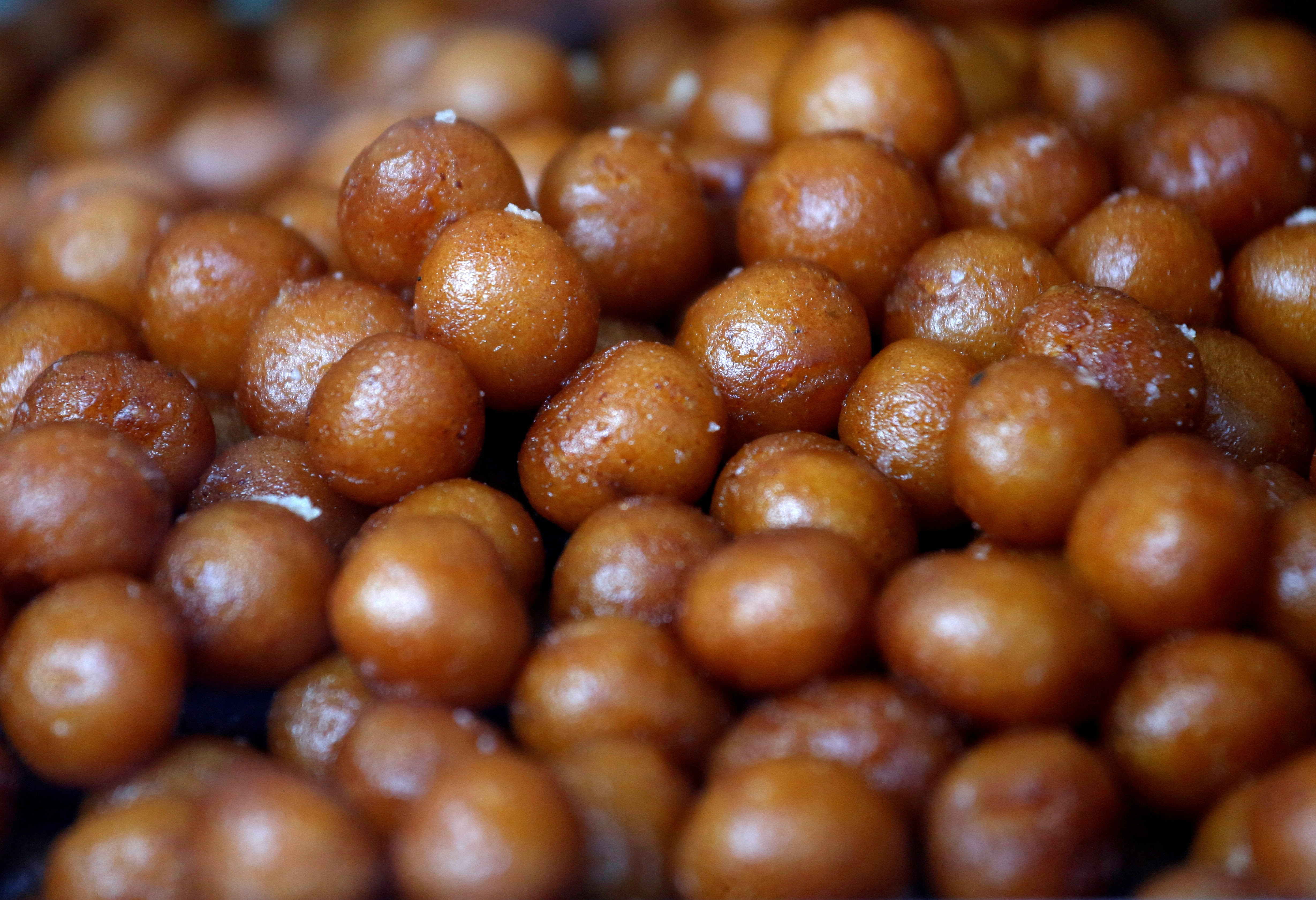 Gulab jamuns (traditional Indian sweet) are on display for sale at a sweets shop in Mumbai