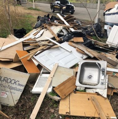 metal sink, doors, other house construction debris that has been dumped