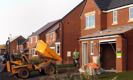 House near completion with dump truck on front lawn.