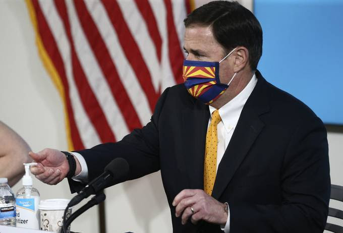Arizona Gov. Doug Ducey (R) gives a coronavirus update at a news conference. (Ross Franklin/AP)