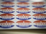 In this June 2, 2020, file photo, stickers for voters casting their ballots in the Pennsylvania primary sit on a table in Philadelphia. The civic ritual of casting a ballot has been disrupted by a global pandemic and dramatically animated by social unrest. (AP Photo/Matt Rourke, File)