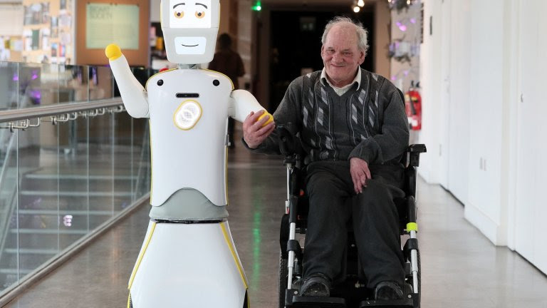 Stevie the robot helps an elderly patient