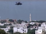 A U.S. Army Blackhawk helicopter patrols Mogadishu in the wake of gun battles between gunmen and U.N. peacekeepers protecting the U.N. military headquarters, June 8, 1993. The city remained on edge after a night of clashes. (AP Photo/Kathy Willens)