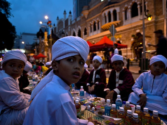 Children break their fast on the first day of Ramadan in Kuala Lumpur, Malaysia.