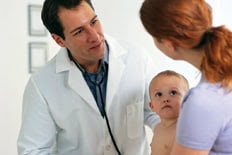 mother with baby talking with physician