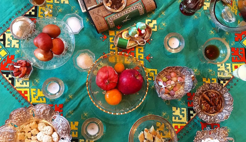 The haftseen table, one of the main customs of Nowruz, includes seven items to symbolize wishes for the year to come. Niloo Farhad’s haftseen includes several extra items, like burnt cookies, candies, and a mirror for splashing rosewater when arriving hom