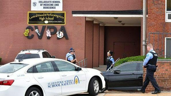St. Louis police stand outside an entrance of the Central Visual and Performing Arts High School after shooting