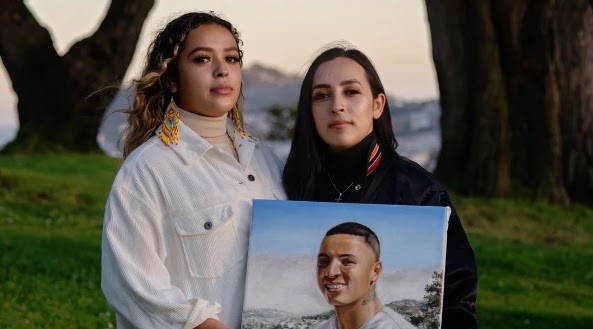 Michelle and Ashley holding a picture of their brother, Sean Monterrosa