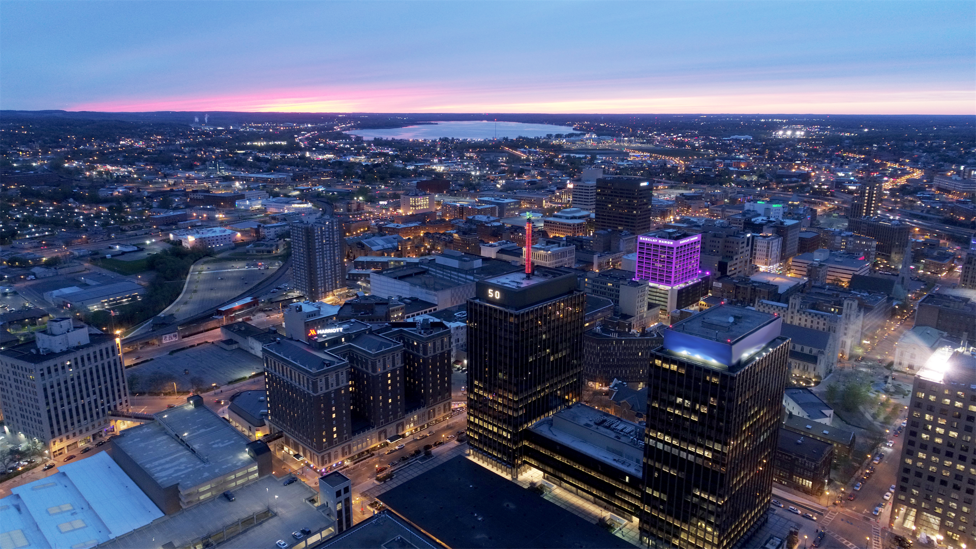Nighttime aerial image of downtown Syracuse 