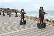 Tourists ride segways down a promenade in Tel Aviv.