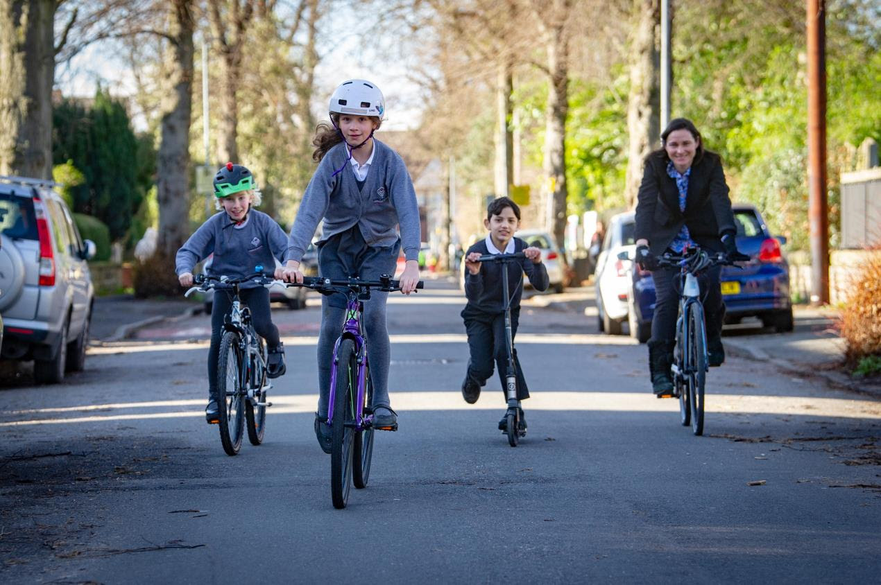 Dame Sarah cycles with pupils from Manley Park Primary School 