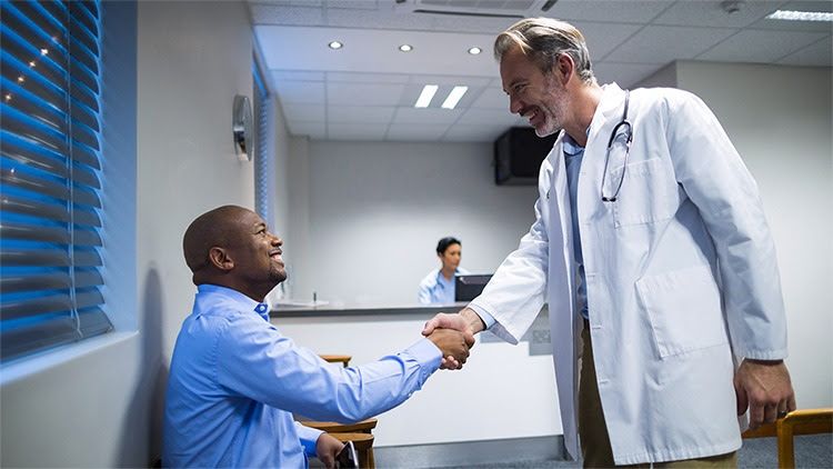 The figure shows a male doctor shaking hands with a patient in the hospital.