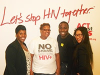 Photo of three women and one man standing in front of Let's Stop HIV Together backdrop.