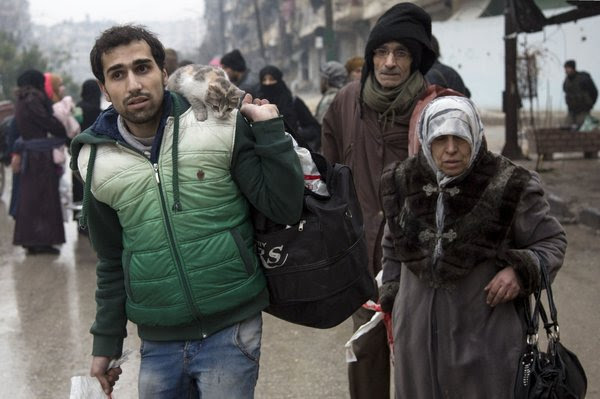 Syrians fleeing a rebel-held area of Aleppo on Tuesday. Evacuations were set to begin early today, but there were reports of delays and renewed shelling.