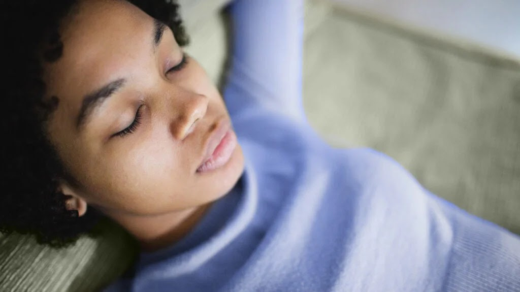 woman lying down with eyes closed