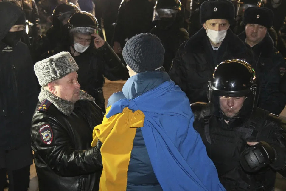 Police officers detain a protester in Nizhny Novgorod, Russia, Thursday, Feb. 24, 2022. Hundreds of people gathered in the center of Moscow, St. Petersburg, Nizhny Novgorod and other Russian cities on Thursday, protesting against Russia's attack on Ukraine. Many of the demonstrators were detained. Similar protests took place in other Russian cities, and activists were also arrested. (AP Photo/Dmitri Lovetsky)