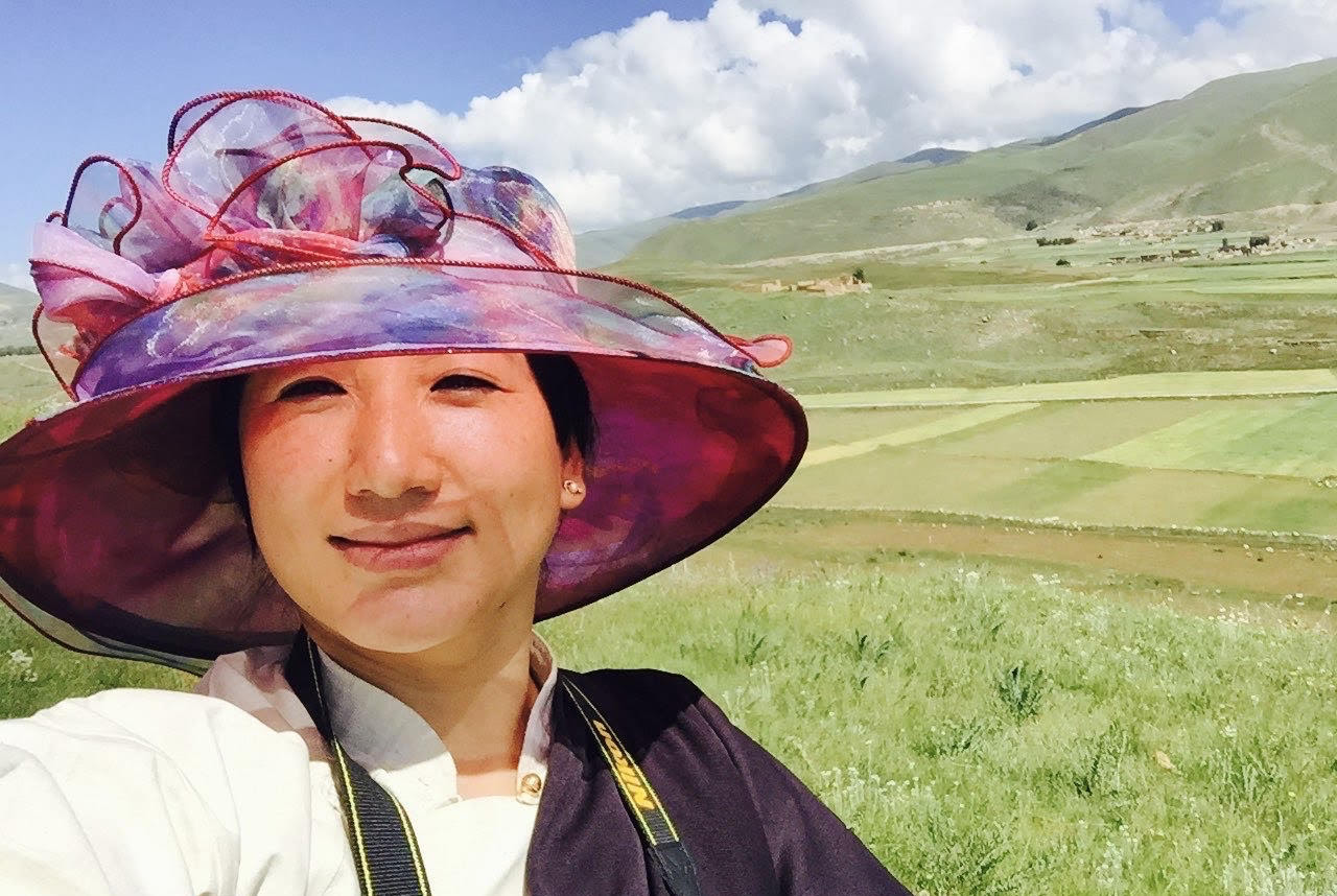 image of a woman called Lobsang Yangtso in a field wearing a hat