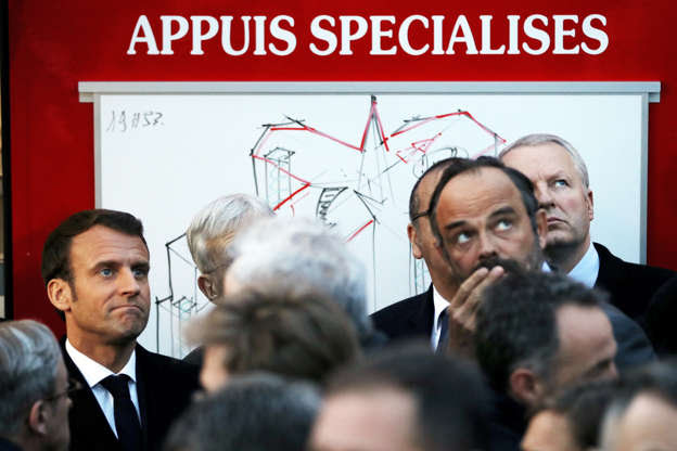 Slide 2 of 31: French President Emmanuel Macron and Prime Minister Edouard Philippe react as they watch the fire at the Notre Dame Cathedral as its burns in Paris, France, April 15, 2019. REUTERS/Philippe Wojazer/Pool