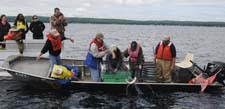 Teachers help DNR staff lift a gill net from Higgins Lake.