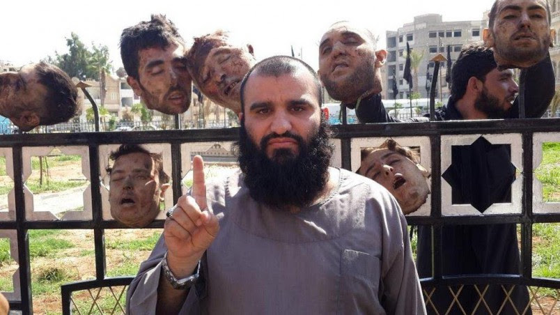 ISIS                                         jihadist posing with severed                                         heads in Syria