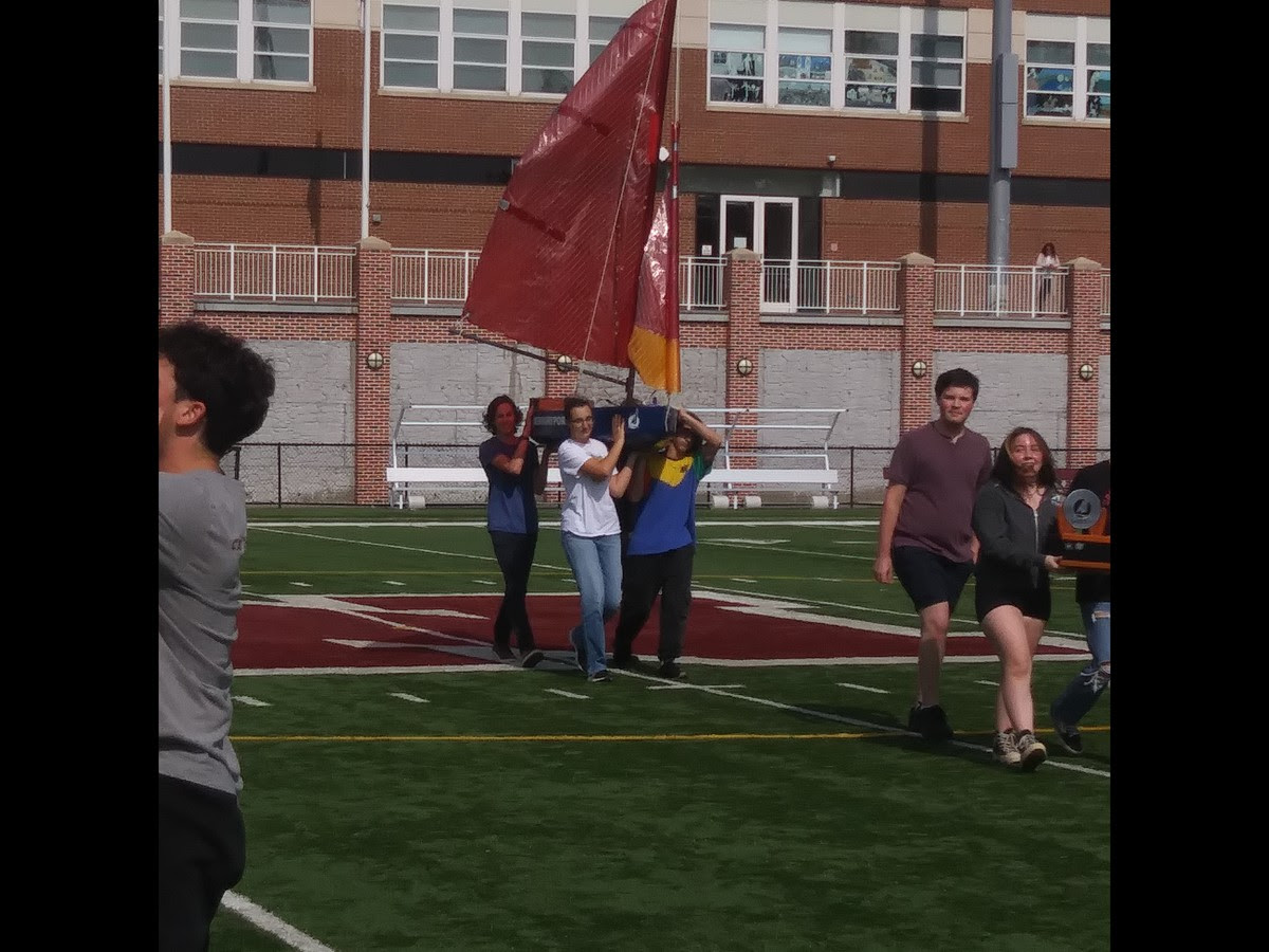 Sailbot team parades their winning boat at the rally