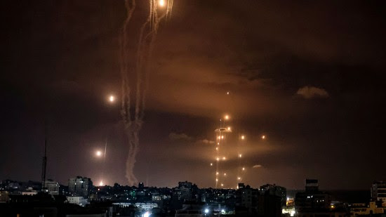 Rockets fired by Palestinian militants from Gaza City, are intercepted by the Israeli Iron Dome defence missile system on October 7, 2023.