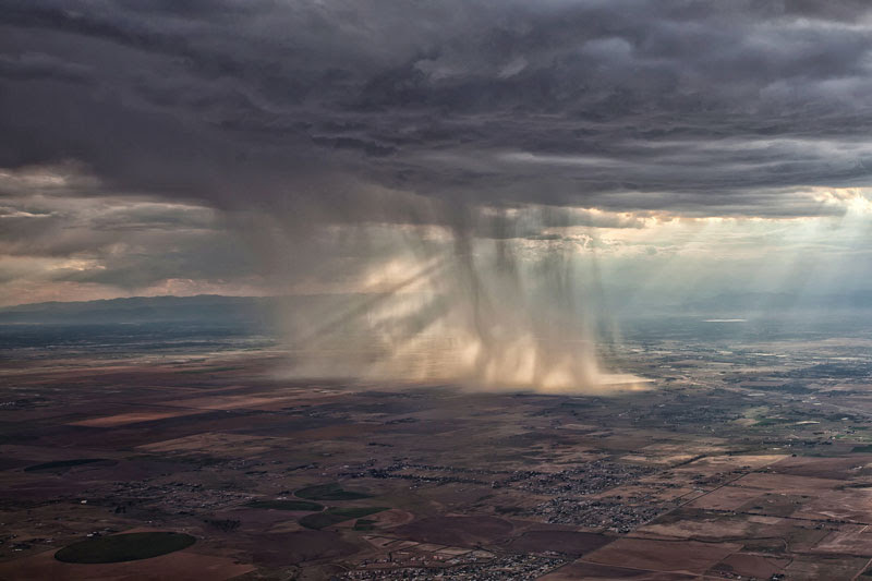 distant storm cloud seen from airplane window 27 Reasons You Should ALWAYS Ask for a Window Seat