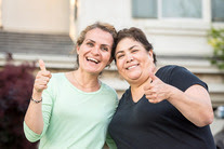 Two women giving the thumbs up