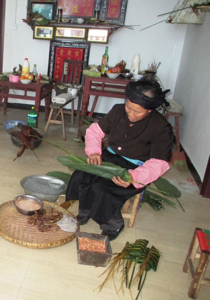 Yaya's Mother made sticky rice packages of bacon, nuts, leaves and charcoal rice.