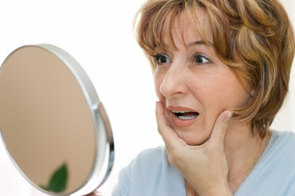 mature woman looking mirror
