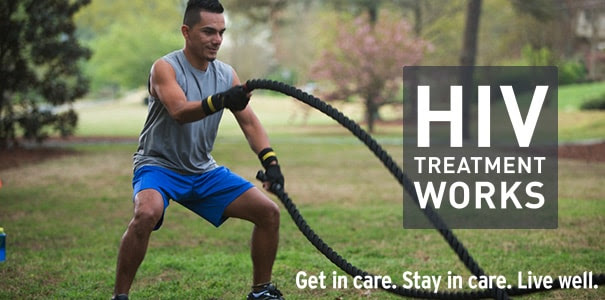 Physically fit man exercising with ropes