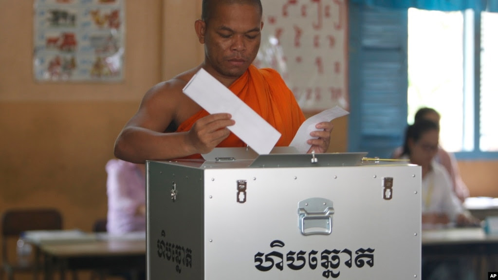 FILE - A Buddhist monk votes at a polling station in Phnom Penh, Cambodia, Sunday, July 29, 2018. With the main opposition silenced, Cambodians were voting in an election Sunday virtually certain to return to office Prime Minister Hun Sen and his party (AP Photo/Heng Sinith)