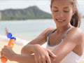 Screen shot from video of woman applying sun screen