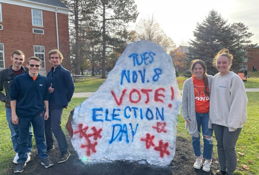 Photo of students around spirit rock that says Vote Nov. 8