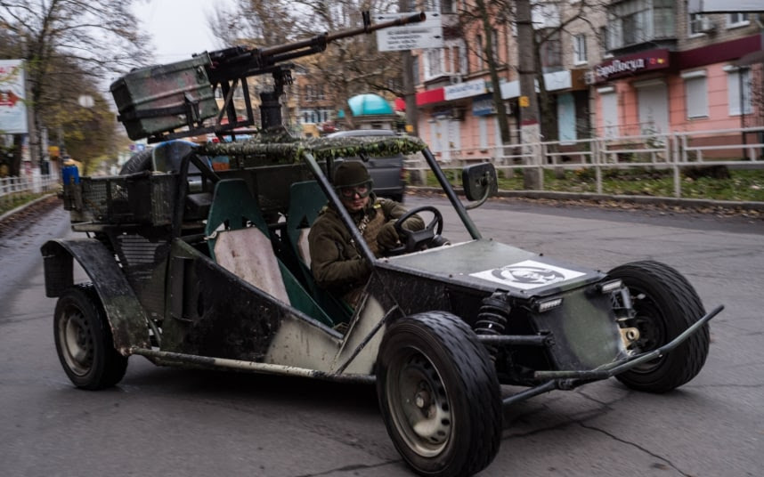 A Ukrainian citizen patrols the streets of Kherson in a homemade assault vehicle.