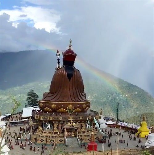 An auspicious rainbow crowns the statue of Guru Rinpoche in Takila during the empowerments From Dzongsarjamyangkhyentsefanclub Facebook