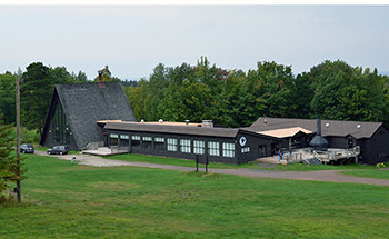 An exterior autumn photo shows the Porcupine Mountains Sports Complex chalet.