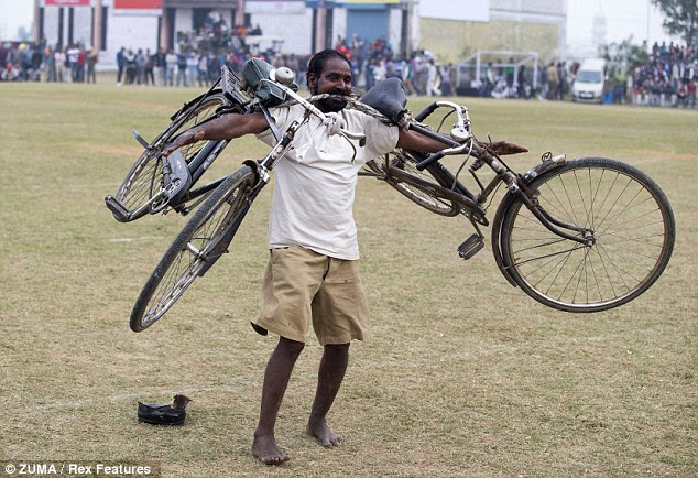 Bizarre: This competitor proved he had what it took to lift two bicycles with his teeth 