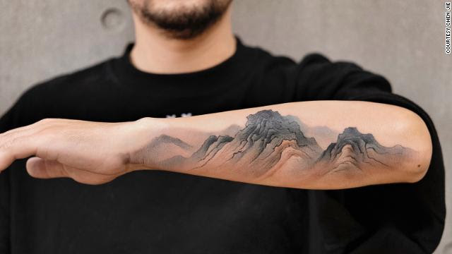 An arm bearing a tattoo.