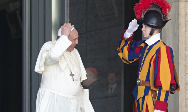 A Swiss Guard salutes Pope Francis at the Vatican