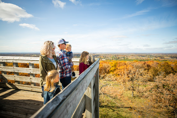 An image of a family sight seeing at the top of a tower in Wisconsin.