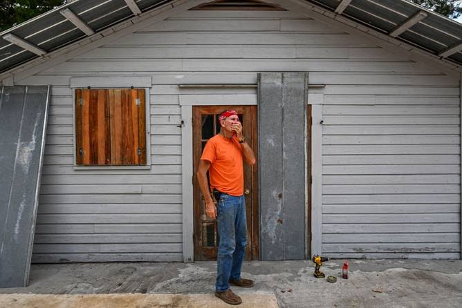 William Doherty bords up his house in preparation for Hurricane Idalia, in Steinhatchee, Florida, on August 29, 2023. 