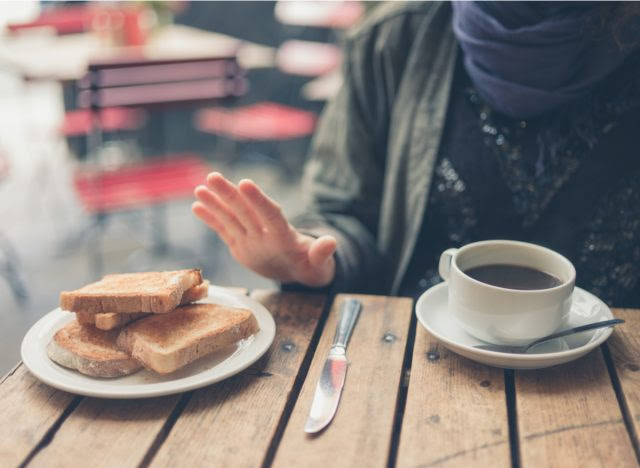 woman pushing bread away