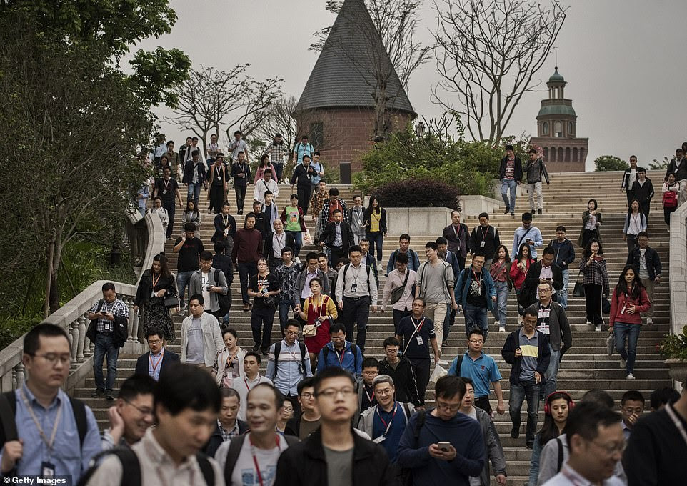 Huawei workers leave at the end of the work day and head to the trains that would take them back to Shenzhen city