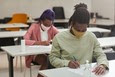 black students in mask in class working